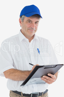 Confident courier man writing on clipboard