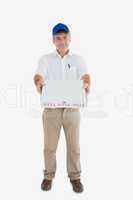 Mature delivery man giving pizza box