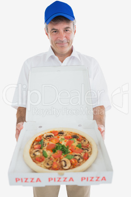 Mature delivery man holding pizza