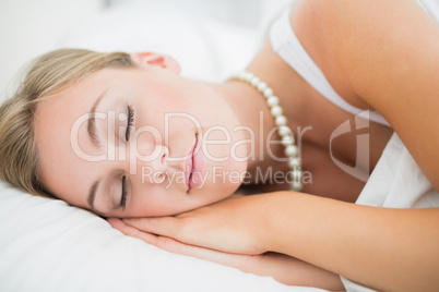 Sleeping cute woman with pearls necklace