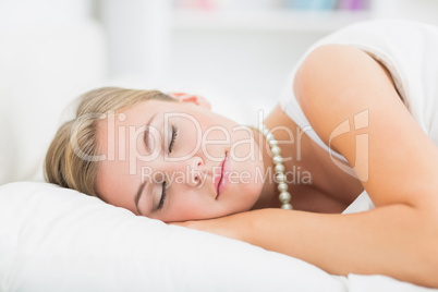 Sleeping blonde woman with pearls necklace