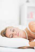 Sleeping woman with white pearls necklace