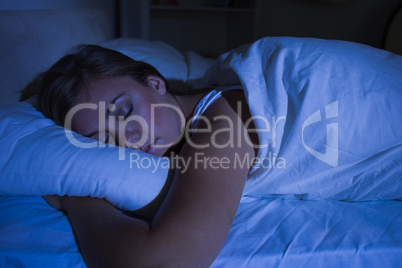 Blonde woman sleeping at night