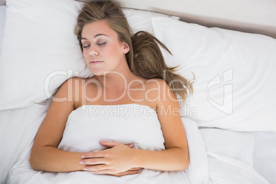 Calm woman sleeping in white bedroom