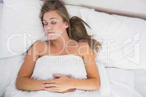 Calm woman sleeping in white bedroom