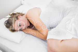 Blonde woman thinking in the bed