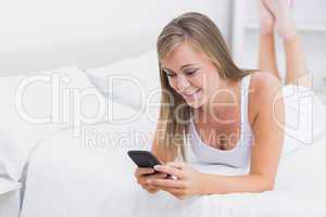 Cheerful woman using her phone