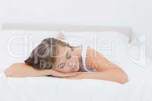 Blonde woman napping on the bed