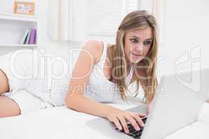 Blonde woman typing on the laptop