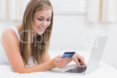 Beautiful woman using her credit card on the web