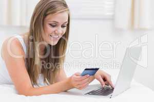 Beautiful woman using her credit card on the web