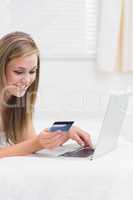 Cheerful woman buying on website