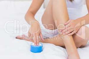 Woman putting some moisturising cream