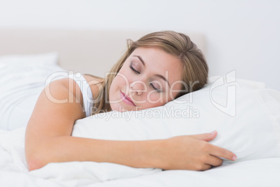 Cheerful woman sleeping in white bedroom