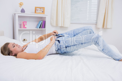 Upset woman trying to close her jeans