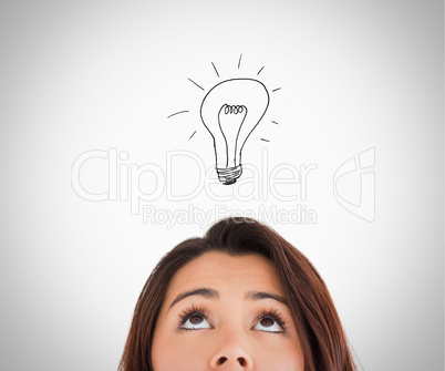 Brunette woman looking up on the bulb