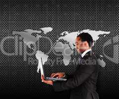Smiling man in suit holding a laptop
