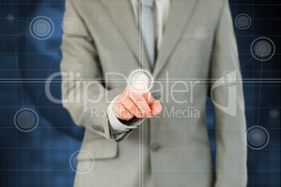 Businessman's finger activating futuristic touchscreen