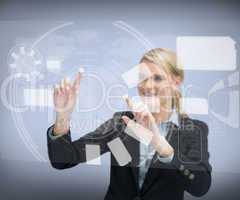 Smiling businesswoman`s finger touching screen