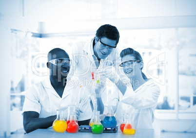 Group of smiling scientists examining test-tubes