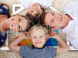 Smiling young family in front of house illustration