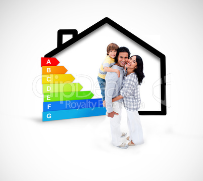 Smiling family standing with a black house illustration with ene