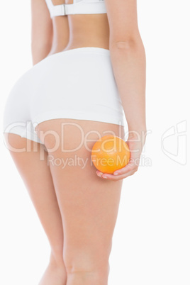 Woman in shorts with orange