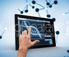 Hand touching a dna on a digital tablet