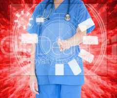 Woman in scrubs standing against a red background