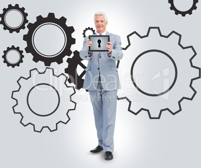 Businessman standing against a cogs background