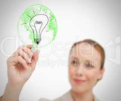 Woman drawing picture of globe and bulb