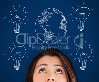 Woman standing against a picture of bulbs and globe