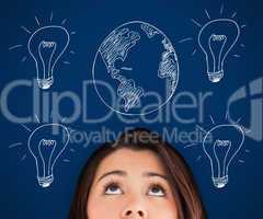 Woman standing against a picture of bulbs and globe