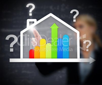 Businesswoman working with energy efficient house graphic with q