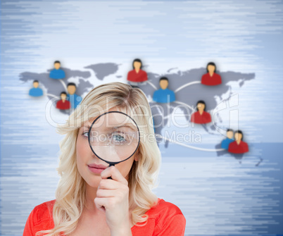 Blonde woman looking through the magnifier