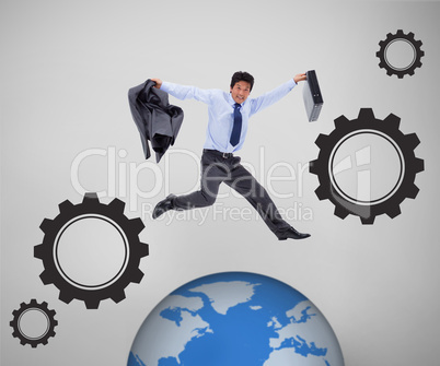 Businessman jumping above picture of the world