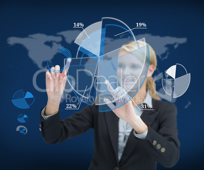 Smiling businesswoman touching screen with graphs