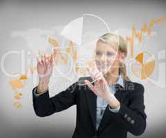 Businesswoman`s finger touching graphs on the screen