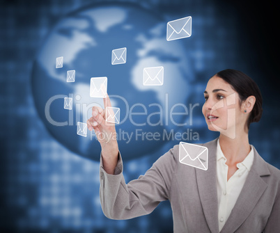 Brunette businesswoman pressing envelope on touch screen