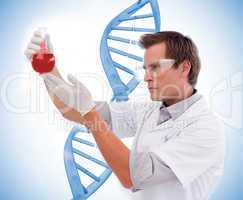 Scientist looking at beaker of blood