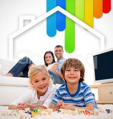 Two children lying on a carpet in the living room with parents