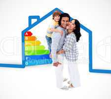 Smiling family standing with a blue house illustration with ener