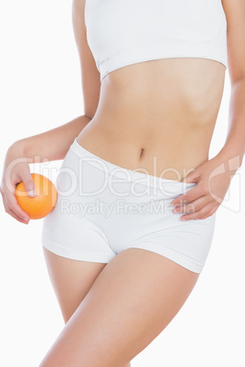 Slim woman with fresh orange