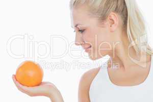Woman looking at fresh orange