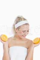 Happy woman looking at sliced orange