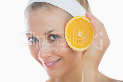 Happy female holding orange slice