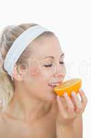 Woman enjoying slice of orange