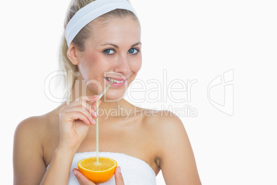 Happy young woman drinking orange juice