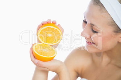 Happy woman holding orange slices