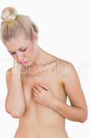 Sad woman covering breasts
